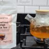 Brewing CHIU STYLE Caramelized Orange Black Tea in a glass teapot using a tea bag