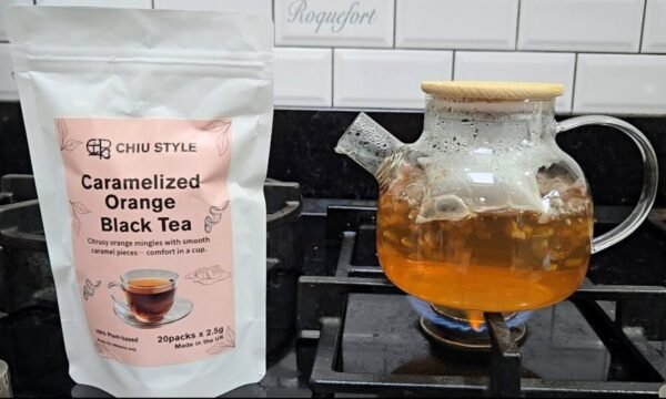 Brewing CHIU STYLE Caramelized Orange Black Tea in a glass teapot using a tea bag