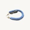 Side profile view of the CHIU STYLE Braided Keychain in Cornflower Blue resting on a textured surface.
