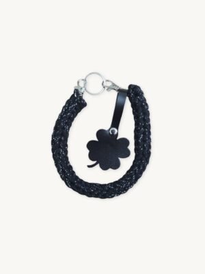 Front view of the CHIU STYLE clover vegan leather braided keychain in black with silver thread, featuring a matching die-cut four-leaf clover tag and polished silver hardware