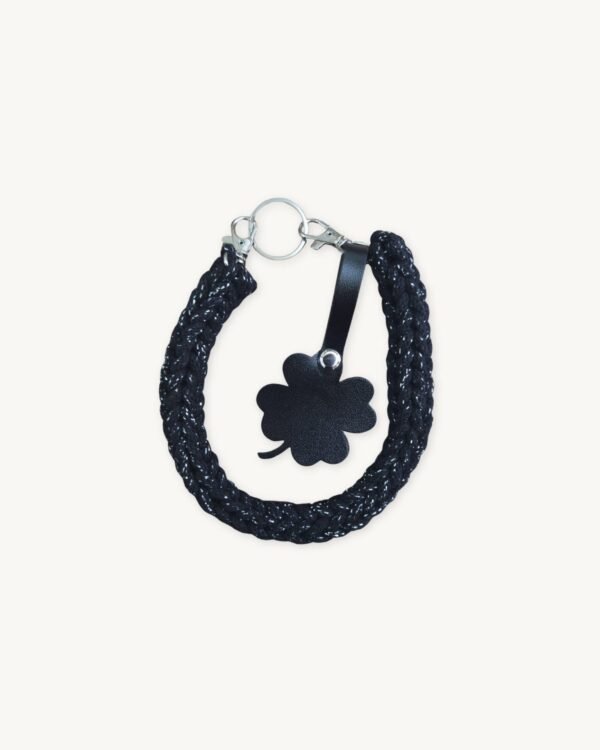 Front view of the CHIU STYLE clover vegan leather braided keychain in black with silver thread, featuring a matching die-cut four-leaf clover tag and polished silver hardware