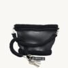 Black vegan leather braided keychain looped around a tote bag handle, demonstrating easy key access inside a handbag