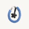 Front view of the CHIU STYLE floral vegan leather braided keychain in Cornflowers Blue, featuring a burnt umber die-cut flower tag and polished silver hardware