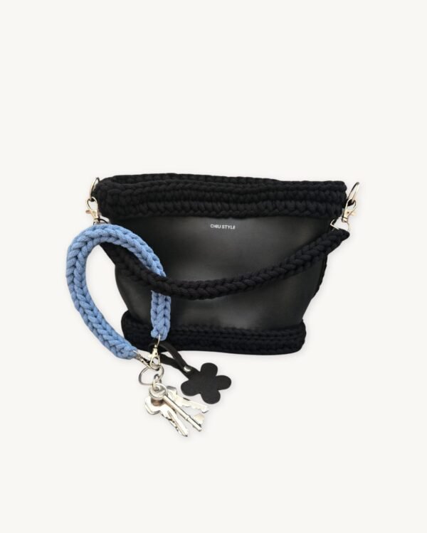 Cornflowers Blue floral vegan leather braided keychain looped around a tote bag handle, demonstrating easy key access inside a handbag