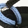 Close-up detailed view of the Cornflowers Blue floral vegan leather braided keychain looped around a handbag handle inside a tote