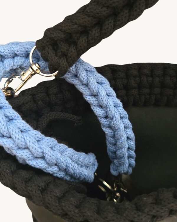 Close-up detailed view of the Cornflowers Blue floral vegan leather braided keychain looped around a handbag handle inside a tote