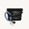 Cornflowers Blue floral vegan leather braided keychain looped around a tote bag handle, demonstrating easy key access inside a handbag