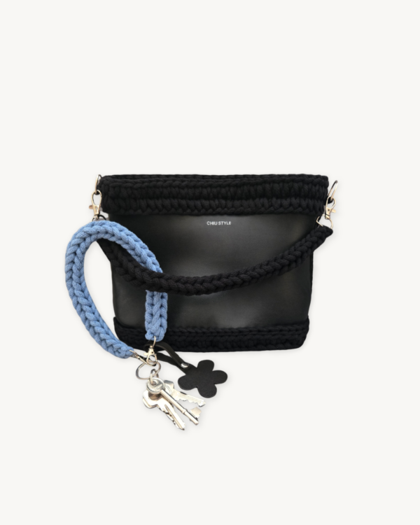 Cornflowers Blue floral vegan leather braided keychain looped around a tote bag handle, demonstrating easy key access inside a handbag