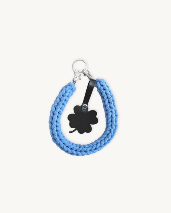 Front view of the CHIU STYLE clover vegan leather braided keychain in cornflower blue, featuring a matching die-cut four-leaf clover tag and polished silver hardware