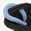 Close-up detailed view of the cornflower blue clover vegan leather braided keychain looped around a handbag handle inside a tote