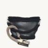 Earth Mocha vegan leather braided keychain looped around a leather tote bag handle, demonstrating easy key access inside handbag