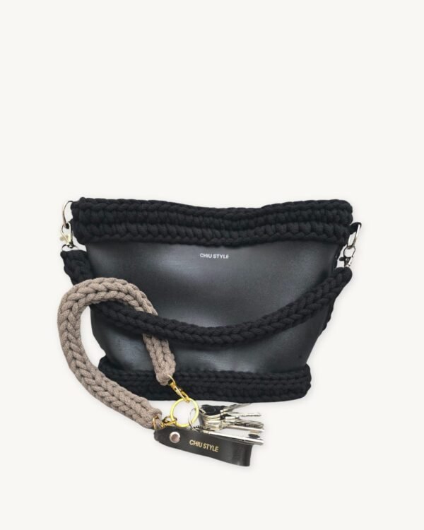 Earth Mocha vegan leather braided keychain looped around a leather tote bag handle, demonstrating easy key access inside handbag