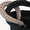 Close-up detailed view of the Earth Mocha vegan leather braided keychain looped around a structured handbag handle inside a tote