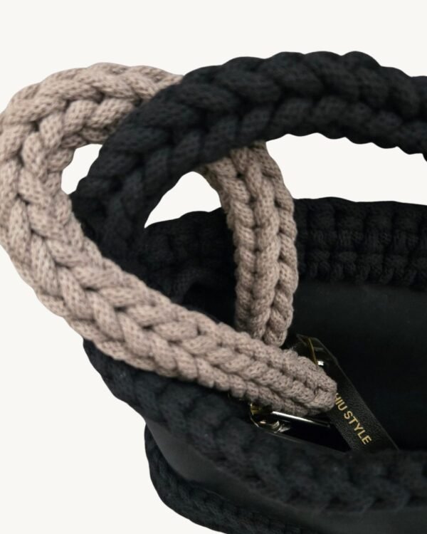 Close-up detailed view of the Earth Mocha vegan leather braided keychain looped around a structured handbag handle inside a tote