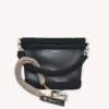 Earth Mocha vegan leather braided keychain looped around a leather tote bag handle, demonstrating easy key access inside handbag