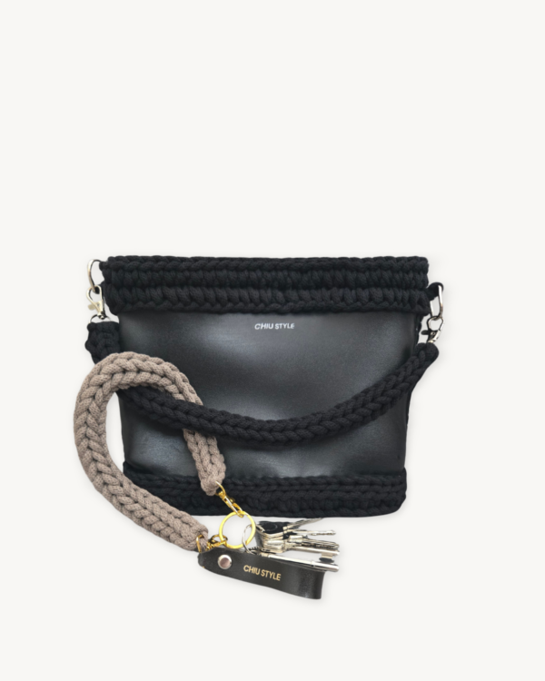 Earth Mocha vegan leather braided keychain looped around a leather tote bag handle, demonstrating easy key access inside handbag