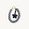 Front view of the CHIU STYLE floral vegan leather braided keychain in mocha brown, featuring a matching die-cut flower tag and polished silver hardware