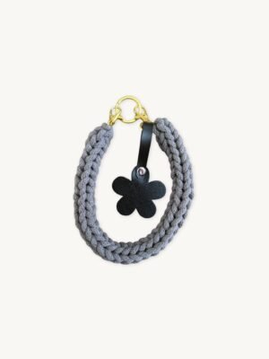 Front view of the CHIU STYLE floral vegan leather braided keychain in mocha brown, featuring a matching die-cut flower tag and polished silver hardware