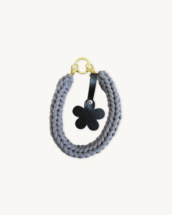 Front view of the CHIU STYLE floral vegan leather braided keychain in mocha brown, featuring a matching die-cut flower tag and polished silver hardware