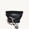 Mocha floral vegan leather braided keychain looped around a tote bag handle, demonstrating easy key access inside a handbag