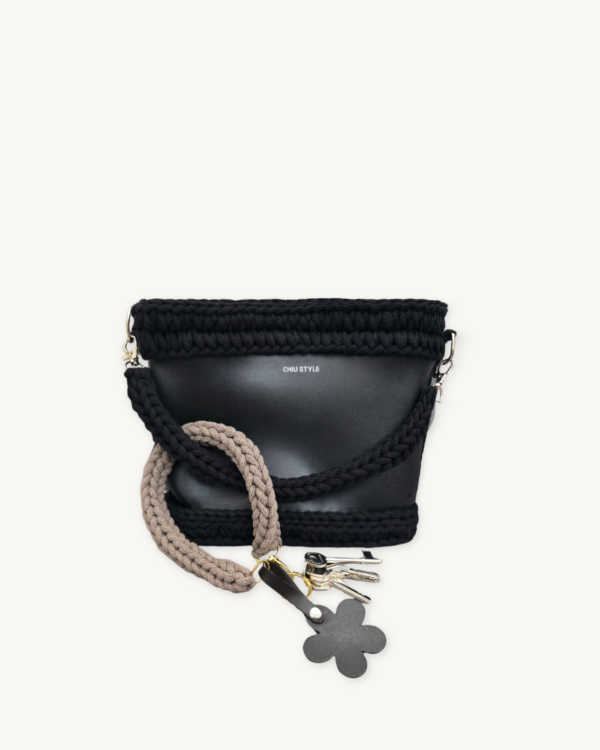 Mocha floral vegan leather braided keychain looped around a tote bag handle, demonstrating easy key access inside a handbag
