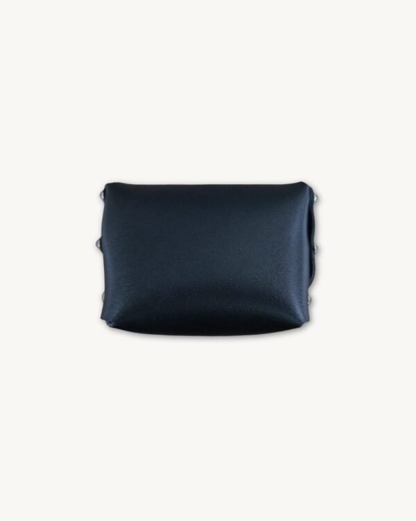 Back view of the black minimalist vegan leather micro wallet, showing the smooth surface and the reverse side of the two Chicago screws.