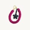 Front view of the CHIU STYLE floral vegan leather braided keychain in Sangria, featuring a burnt umber die-cut flower tag and polished metal clasps