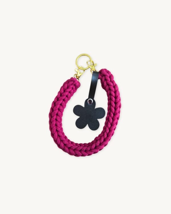 Front view of the CHIU STYLE floral vegan leather braided keychain in Sangria, featuring a burnt umber die-cut flower tag and polished metal clasps