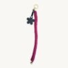 Full length straight view of the 36-38cm CHIU STYLE floral vegan leather braided keychain in Sangria, highlighting its complete structure and flower tag