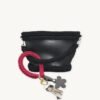 Sangria floral vegan leather braided keychain looped around a tote bag handle, demonstrating easy key access inside a handbag