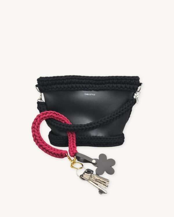 Sangria floral vegan leather braided keychain looped around a tote bag handle, demonstrating easy key access inside a handbag