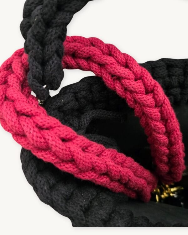 Close-up detailed view of the Sangria floral vegan leather braided keychain looped around a luxury handbag handle inside a tote