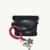 Sangria floral vegan leather braided keychain looped around a tote bag handle, demonstrating easy key access inside a handbag