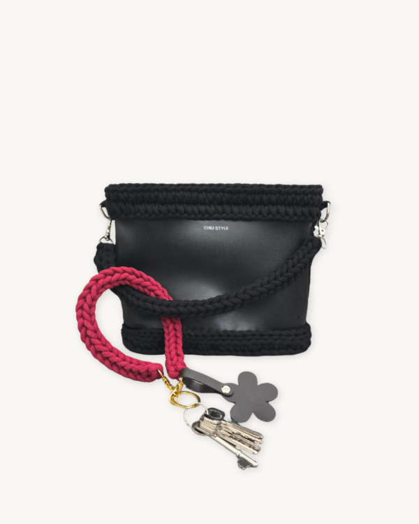Sangria floral vegan leather braided keychain looped around a tote bag handle, demonstrating easy key access inside a handbag