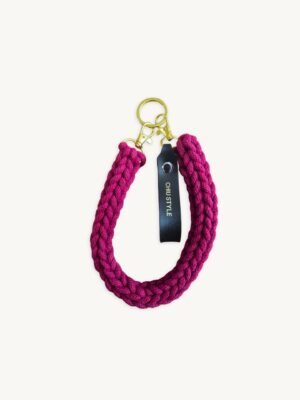 Front view of the CHIU STYLE vegan leather braided keychain in Sangria, featuring a rich warm brown logo tag and polished metal clasps
