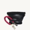 Sangria vegan leather braided keychain looped around a leather tote bag handle, demonstrating easy key access inside handbag