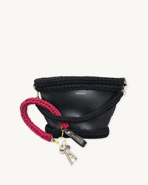 Sangria vegan leather braided keychain looped around a leather tote bag handle, demonstrating easy key access inside handbag