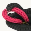 Close-up detailed view of the Sangria vegan leather braided keychain looped around a structured handbag handle inside a tote