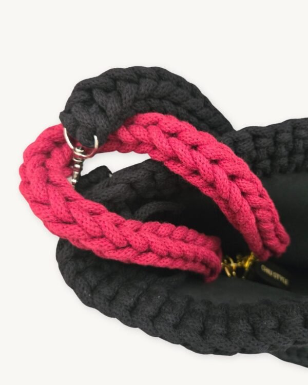 Close-up detailed view of the Sangria vegan leather braided keychain looped around a structured handbag handle inside a tote