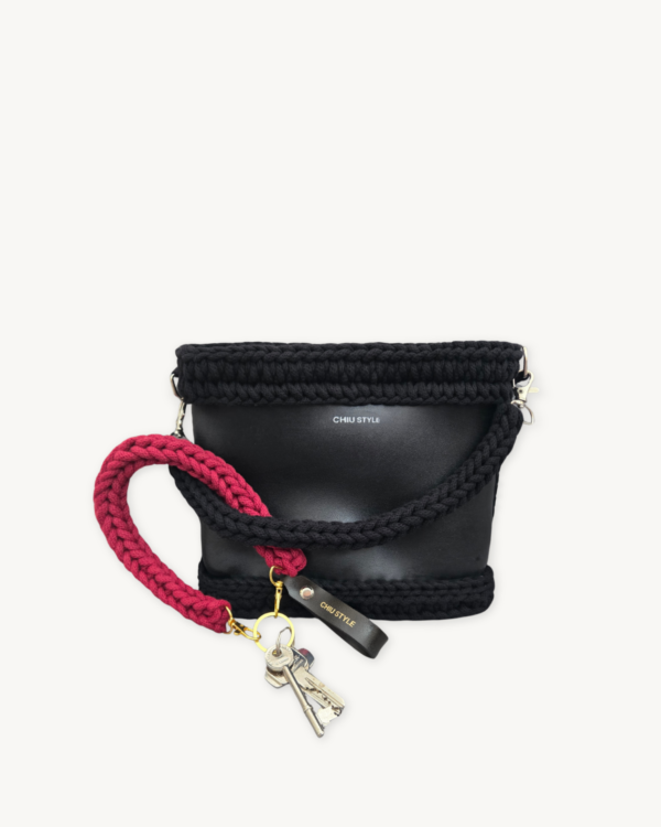 Sangria vegan leather braided keychain looped around a leather tote bag handle, demonstrating easy key access inside handbag