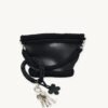 Black with Silver Thread floral vegan leather braided keychain looped around a tote bag handle, demonstrating easy key access inside a handbag
