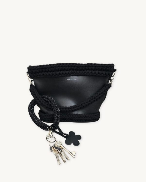 Black with Silver Thread floral vegan leather braided keychain looped around a tote bag handle, demonstrating easy key access inside a handbag