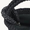 Close-up detailed view of the Black with Silver Thread floral vegan leather braided keychain looped around a handbag handle inside a tote