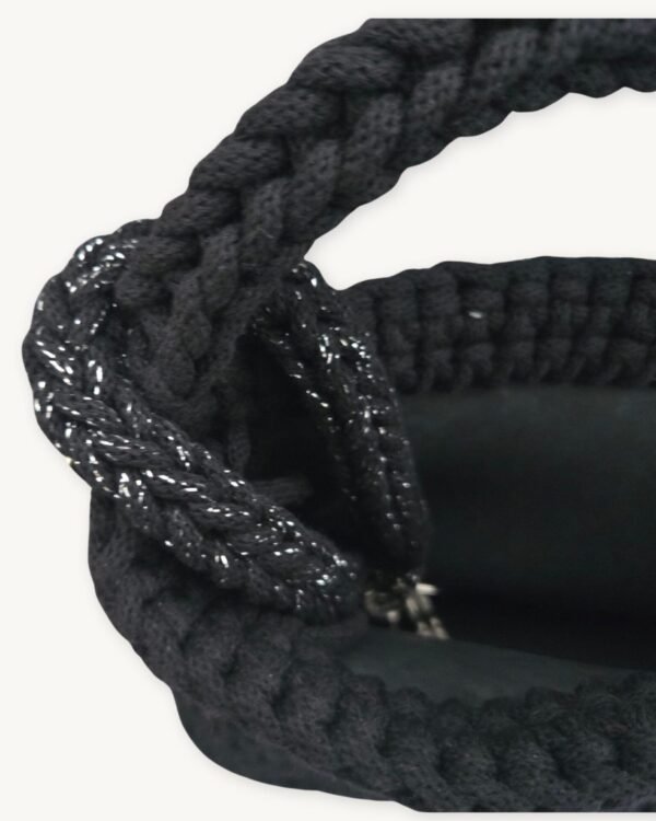 Close-up detailed view of the Black with Silver Thread floral vegan leather braided keychain looped around a handbag handle inside a tote