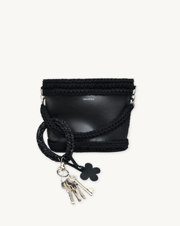 Black with Silver Thread floral vegan leather braided keychain looped around a tote bag handle, demonstrating easy key access inside a handbag