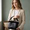 Model holding black Vintage Punk Vegan Leather Classic Handbag by hand in a vintage pale green room