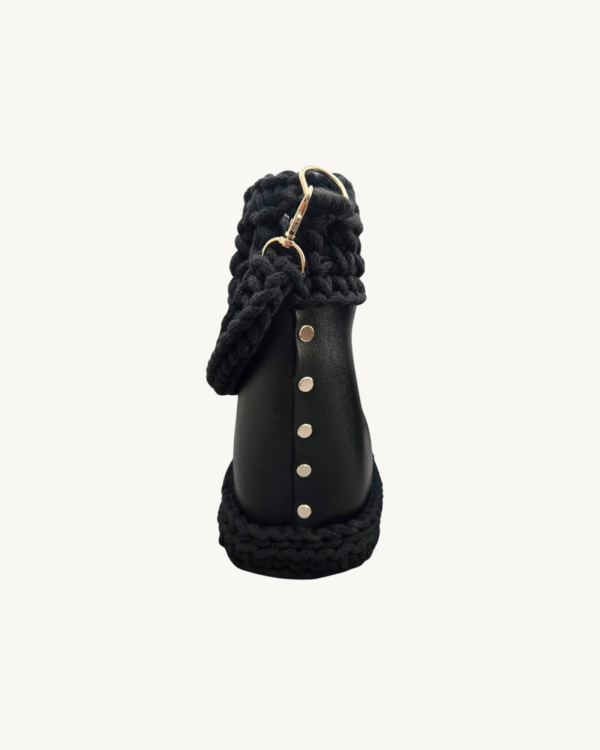 Side view of Vintage Punk Vegan Leather Laced Rhythm Handbag in black showcasing Chicago screw hardware and textured profile