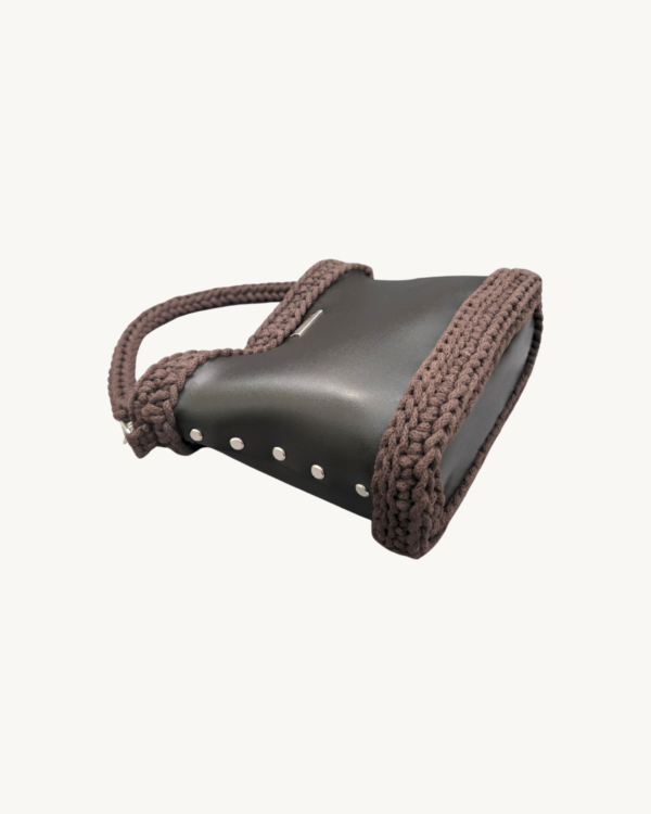 Dark Brown Vintage Punk Vegan Leather Classic Handbag resting sideways on a table showing the structured bottom view