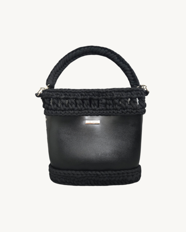 Vintage-Punk-Vegan-Leather-Laced-Rhythm-Handbag-Black-Front-View-Suspended-Handle Front view of Vintage Punk Vegan Leather Laced Rhythm Handbag in black with intricate crochet texture and suspended i-cord handle